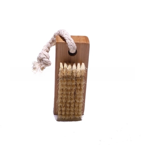 Macro view of beechwood nail brush with stiff bristles and a cotton hanging loop