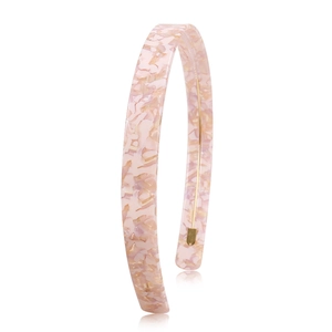 Macro detail of pink marble texture acetate headband with protective metal ends