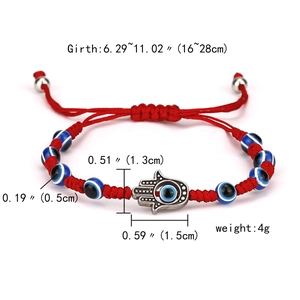 Detail of red woven Evil Eye bracelet with Hamsa Hand pendant and adjustable cord sizing