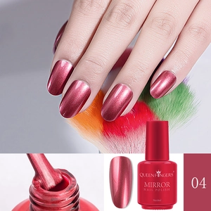 Detail of red metallic mirror nail polish bottle and brush application on nails