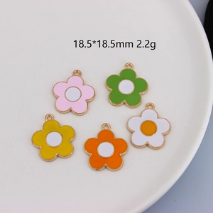 Close-up of five colorful 18.5mm enamel flower pendants for DIY jewelry making
