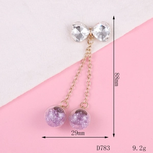 Detail view of bow pendant with chains and purple crystal spheres, 88mm x 29mm size