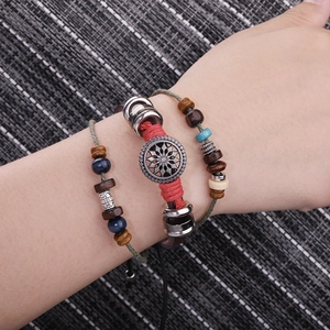 Detail of bohemian leather bracelets with turquoise evil eye and sunflower charms