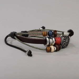 Close-up of multilayer leather bracelet with ethnic wood beads and silver pendant
