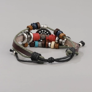 Detail view of multi-strand leather bracelet with turquoise evil eye and wood beads