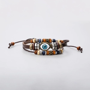 Detailed view of multilayer leather bracelet with evil eye charm and turquoise beads