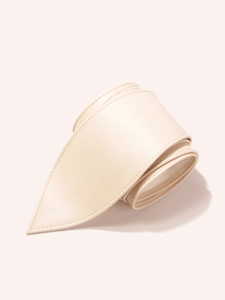 Close-up of cream wide waist belt showing soft PU leather texture and stitched edge detail