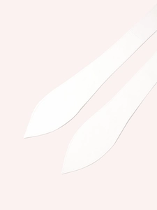 Detail showing the neat stitching and sharp tapered ends of a white fabric waist belt