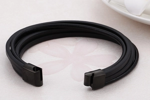 Detail of multi-layer black braided leather bracelet with matte black magnetic clasp