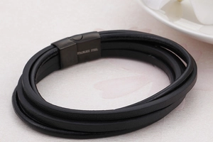 Macro shot of black braided leather multi-layer bracelet with stainless steel magnetic clasp