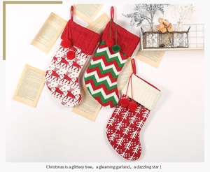 Detail of knitted Christmas stockings with reindeer and snowflake patterns for gifts