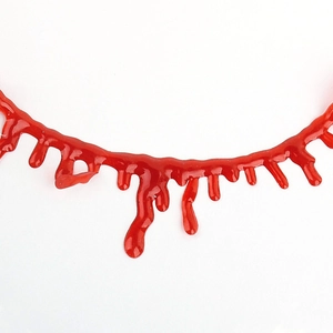 Macro detail of glossy red blood drip necklace for Halloween costume and party decor