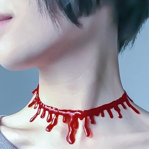 Close-up of Halloween blood drip necklace featuring red gothic style liquid droplet design