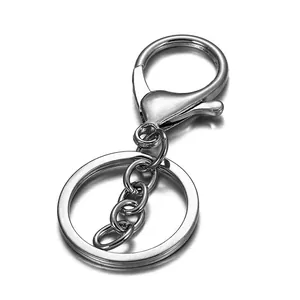 Macro detail of silver lobster clasp and flat key ring with triple link metal connector