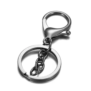 Macro shot of gunmetal lobster clasp with short chain and flat circular keyring