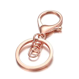 Macro detail of rose gold lobster clasp and flat metal key ring with plating finish
