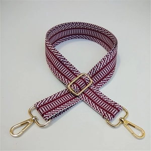 Detail of adjustable crimson and white herringbone strap with gold metal swivel clasps
