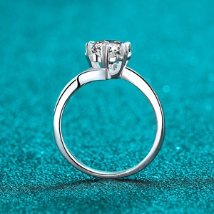 Classic 925 sterling silver ring with six-prong moissanite stone on blue glitter background