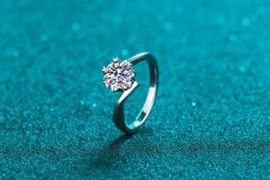 Macro shot of 925 silver snowflake ring with brilliant round moissanite on blue glitter