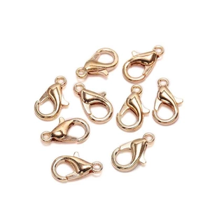 Set of nine gold-plated lobster clasps for DIY jewelry making on white background