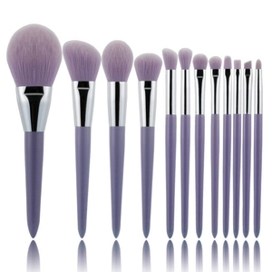 Detail of 14 purple glitter makeup brushes with silver ferrules and synthetic bristles