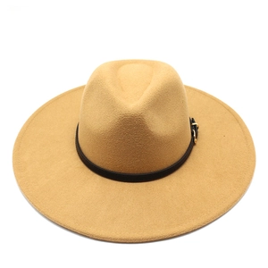 Detail of camel wool fedora hat with a black leather band and gold metal buckle