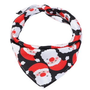 Detailed view of red Christmas dog bandana with Santa Claus print on white background