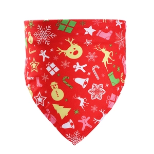 Detailed flat lay of a red Christmas pet bandana with snowflake and reindeer patterns