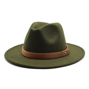 Detail of olive green wool fedora hat featuring a brown leather strap and gold metal rivet