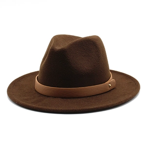 Close-up of dark brown wool fedora with light brown leather band and golden stud