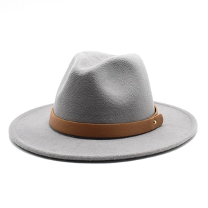 Detail of grey fedora hat texture with brown faux leather band and gold buckle accent