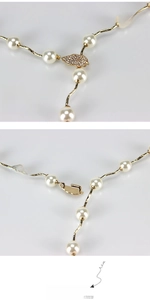 Detail of gold pearl waist chain with crystal leaf clasp and adjustable hook closure