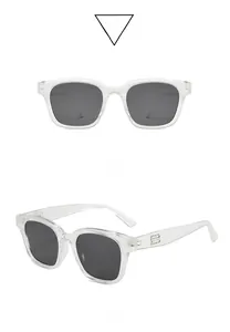 Detail view showing transparent square frame and gray lenses of the fashion sunglasses