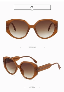 Détail de lunettes de soleil en plastique écaillé avec verres dégradés bruns et code C3