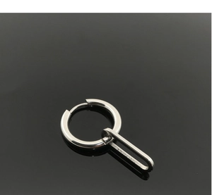 Detailed macro of a polished stainless steel hoop earring with a long oval metal link