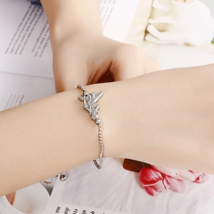 Minimalist silver-tone titanium bracelet with a winged angel pendant for women