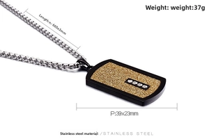 Detailed macro view of men's dog tag pendant with gold glitter and steel box chain