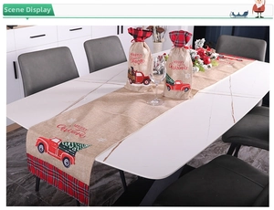 Detail of Christmas table runner and wine covers with red truck and plaid patterns