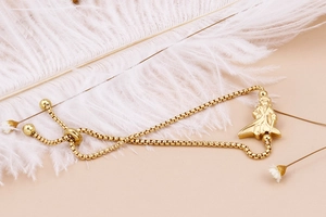 Detailed view of the gold Little Prince pendant on a box chain with adjustable slider
