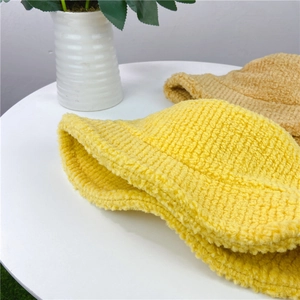 Winter plush bucket hat in yellow and khaki colors with soft twill lamb wool texture