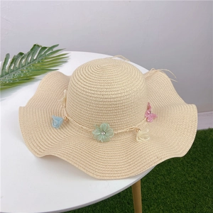 Elegant wide-brimmed straw beach hat for women decorated with colorful lace flower wreath