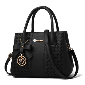 Women's black pebbled leather tote bag with woven patterns and gold metal charms