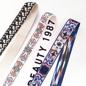 Detail of adjustable bag straps in leopard, ethnic embroidery and geometric patterns