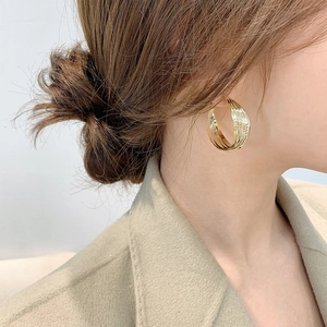 Fashionable large layered gold hoop earrings in a minimalist geometric stacked design