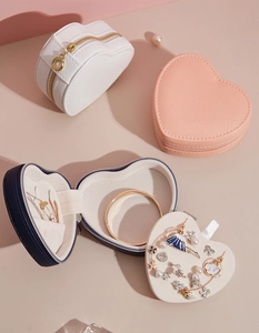 Close-up view of heart-shaped travel jewelry organizer with multi-compartment interior storage