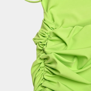 Detailed close-up of side drawstring ruching on a neon green sexy backless bodycon dress