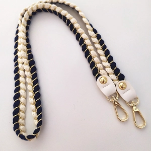 Detailed view of woven blue and cream cotton strap with gold metal lobster clasps