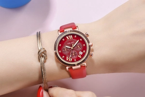 Macro view of YOLAKO women's quartz watch with red leather strap and sunburst dial