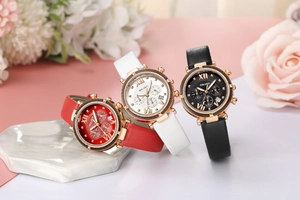 Detailed shot of three quartz watches with leather straps in red, white and black colors