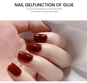 Macro shot of glossy deep red nail gel applied on nails with a crystal shiny finish